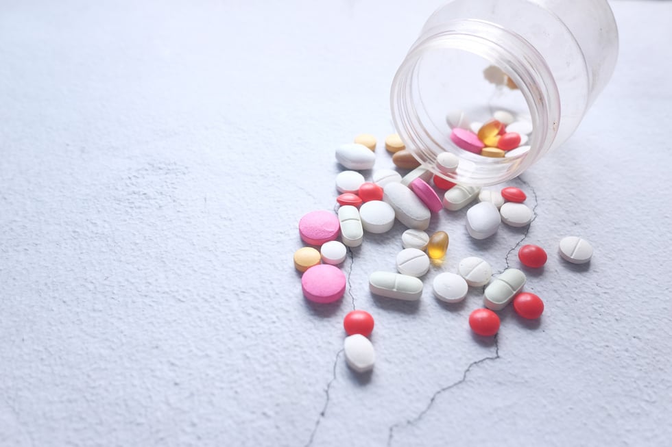 Close up of Colorful Pills Spilling on White Background